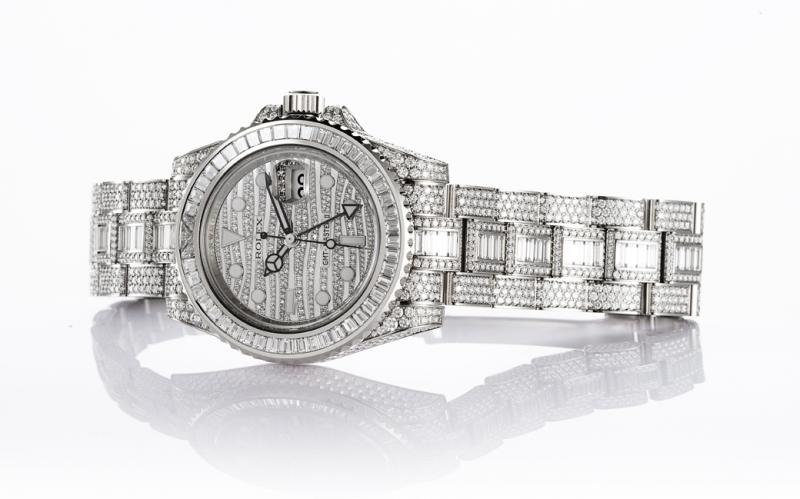 The 18ct white gold fake watch is decorated with diamonds and sapphires.